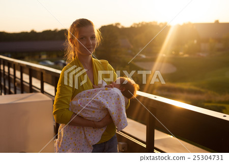 Woman holding a baby  25304731
