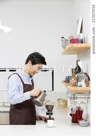 Middleaged Asian Man Making Coffee in Kitchen Middleaged Asian Man Making Coffee in Kitchen 25307056