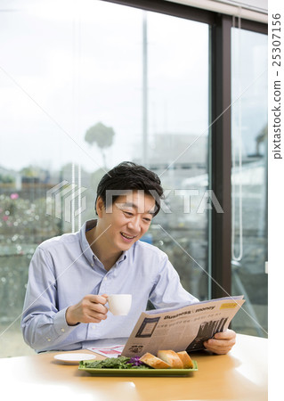 Middleaged Asian Man Reading Newspaper and Having Coffee at Home in the Morning 25307156
