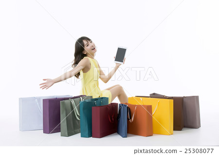 A young woman carrying a bunch of shopping bags A young woman carrying a bunch of shopping bags 25308077
