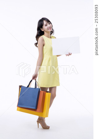 A young woman carrying a bunch of shopping bags A young woman carrying a bunch of shopping bags 25308093