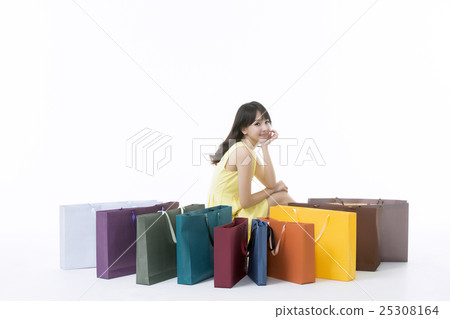 A young woman carrying a bunch of shopping bags A young woman carrying a bunch of shopping bags 25308164