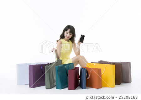 A young woman carrying a bunch of shopping bags A young woman carrying a bunch of shopping bags 25308168