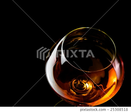 snifter of brandy in elegant glass with space for text snifter of brandy in elegant glass with space for text 25308518