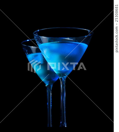 glasses of fresh cocktail with ice on bar table on black background 25308681