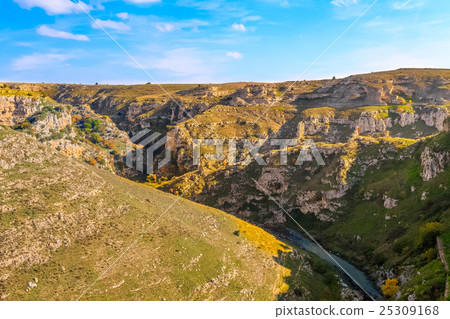 Rupestrian stones, historic building. La Gravina di Matera. Basilicata under blue sky 25309168