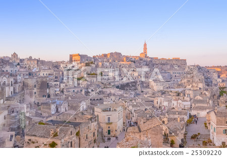 panoramic view of typical stones and church of Matera and the Madonna de Idris under begin sunset sky panoramic view of typical stones and church of Matera and the Madonna de Idris under begin sunset sky 25309220