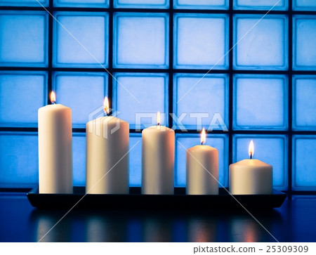 white candles on wood table 25309309