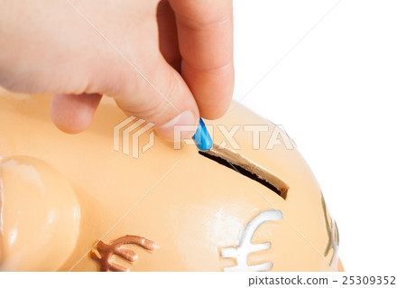 hand inserting a pill into a piggy bank, concept for save money 25309352
