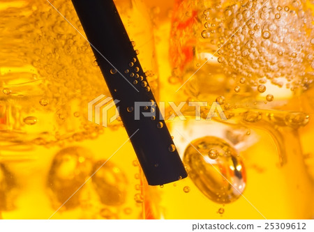 close-up of straw in the yellow cocktail with ice cubes for background close-up of straw in the yellow cocktail with ice cubes for background 25309612
