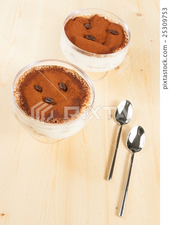 italian tiramisu dessert served in a cup near spoons italian tiramisu dessert served in a cup near spoons 25309753