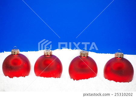 four christmas balls on the snow 25310202