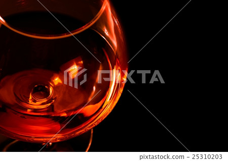 top of view of snifter of brandy in elegant typical cognac glass on black background 25310203