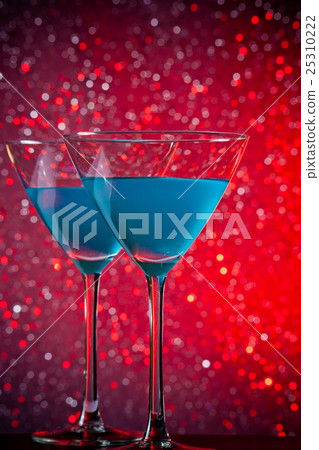 a pair of glasses of blue cocktail on table a pair of glasses of blue cocktail on table 25310222
