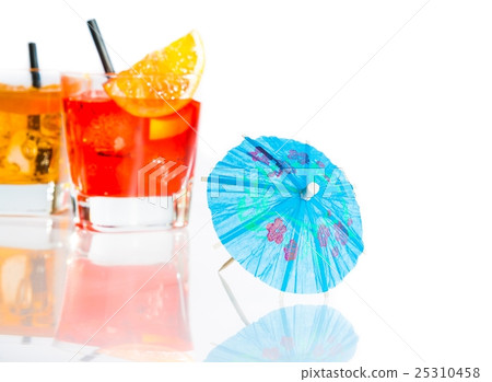 two cocktail with orange slice on top isolated behind blue umbrella on white background two cocktail with orange slice on top isolated behind blue umbrella on white background 25310458