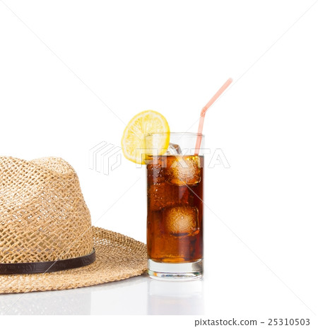 glass of fresh coke with straw near summer hat, summer time glass of fresh coke with straw near summer hat, summer time 25310503