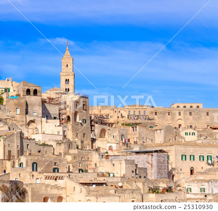 panoramic view of typical stones (Sassi di Matera) and church of Matera under blue sky 25310930