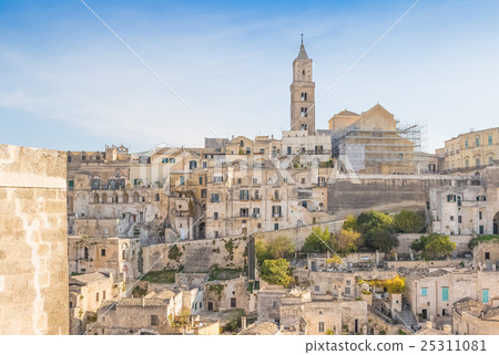 panoramic view of typical stones (Sassi di Matera) and church of Matera UNESCO European Capital of Culture 2019 under blue sky panoramic view of typical stones (Sassi di Matera) and church of Matera UNESCO European Capital of Culture 2019 under blue sky 25311081