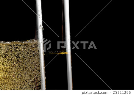 detail of a pair of flutes of champagne with golden bubbles detail of a pair of flutes of champagne with golden bubbles 25311296