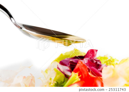spoon with olive oil and drop on italian fresh salad on white spoon with olive oil and drop on italian fresh salad on white 25311743