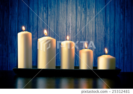 white candles on wood table 25312481