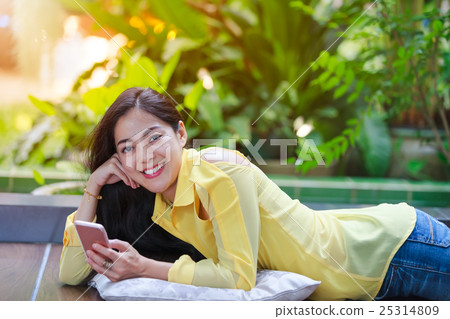 Beautiful asian woman smiling happy at backyard. 25314809