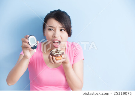 woman holding  blood glucose meter 25319075