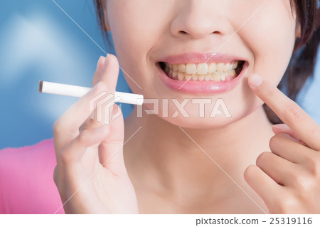 Woman holding cigarettes Woman holding cigarettes 25319116