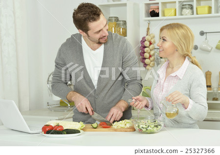 happy couple cooking in kitchen happy couple cooking in kitchen 25327366