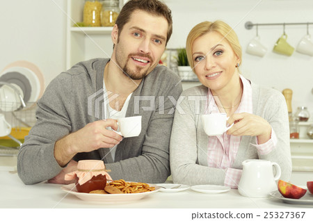 couple at table with coffee and food couple at table with coffee and food 25327367