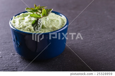 Blue bowl with wasabi dip with piece of herb Blue bowl with wasabi dip with piece of herb 25328959