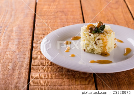 White plate with heap of curry rise with sauce White plate with heap of curry rise with sauce 25328975