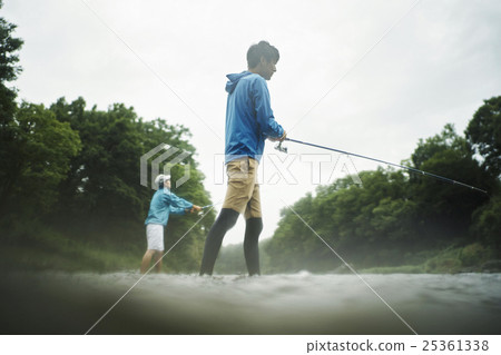 A man who enjoys fly fishing 25361338