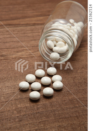 White medicine spilling from a collapsed transparent bottle 25362514