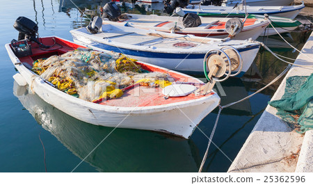 White fishing boats with nets moored in port White fishing boats with nets moored in port 25362596