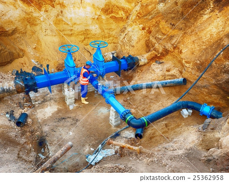 Worker at gate on drink water system,pipe joint Worker at gate on drink water system,pipe joint 25362958