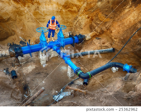 Worker underground at gate valve on water system Worker underground at gate valve on water system 25362962