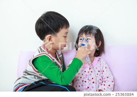 Asian girl having respiratory helped by brother Asian girl having respiratory helped by brother 25363884