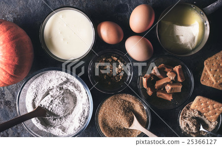 Ingredients for pumpkin dump cake on dark stone Ingredients for pumpkin dump cake on dark stone 25366127
