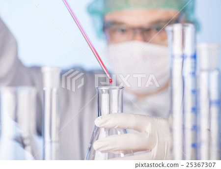 Scientist with pipette and glass flasks 25367307