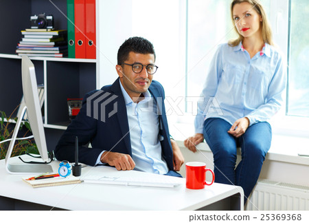 Beautiful young woman and man working from home 25369368