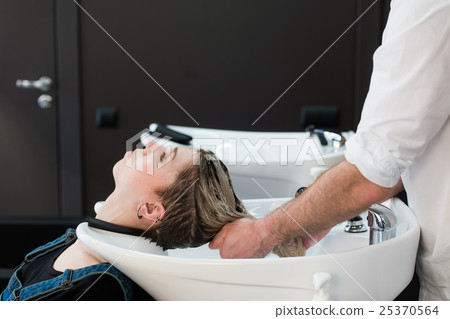 Teenager girl washing hair in hairdressing salon. 25370564