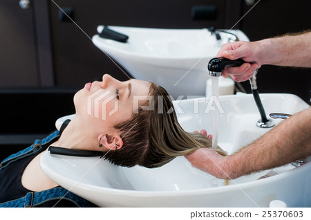 Beautiful woman getting a hair wash in beauty 25370603