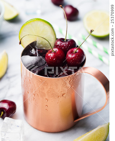 Cold cherry Moscow Mules cocktail with ginger beer 25370999
