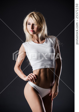 sexy fitness woman pulling hair on dark studio sexy fitness woman pulling hair on dark studio 25371150