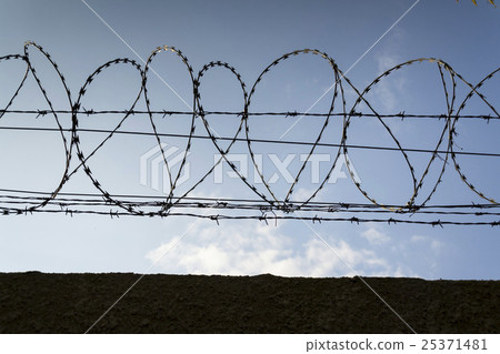 Filtered picture of barbed wire prison fence Filtered picture of barbed wire prison fence 25371481