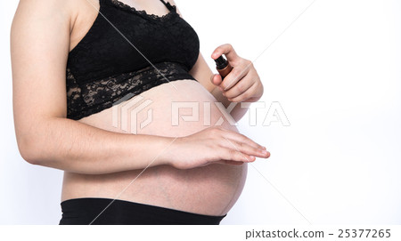 Pregnant Woman Spraying Mosquito Repellent Pregnant Woman Spraying Mosquito Repellent 25377265