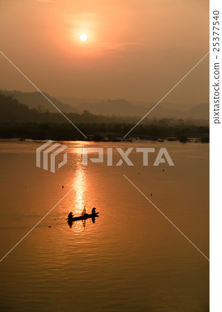 fisherman on boat with sunrise background fisherman on boat with sunrise background 25377540