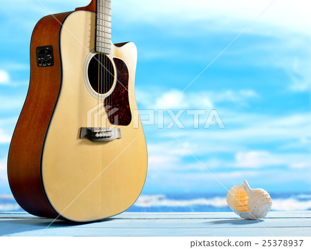 Acoustic guitar and seashell on the beach  25378937