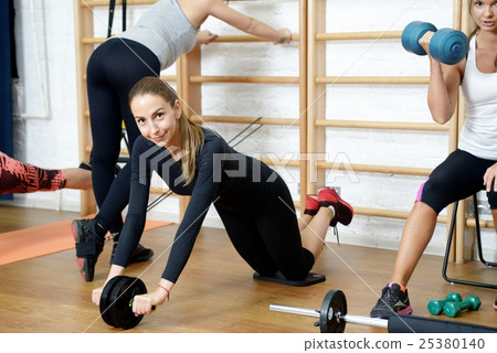 Group of girls doing fitness exercising in gym Group of girls doing fitness exercising in gym 25380140